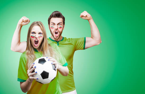 istock Couple Fan / Sport Player on green uniform celebrating 696278424