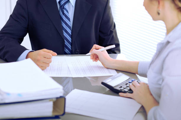 istock Bookkeepers or financial inspector making report, calculating or checking balance. Audit concept. 696280798