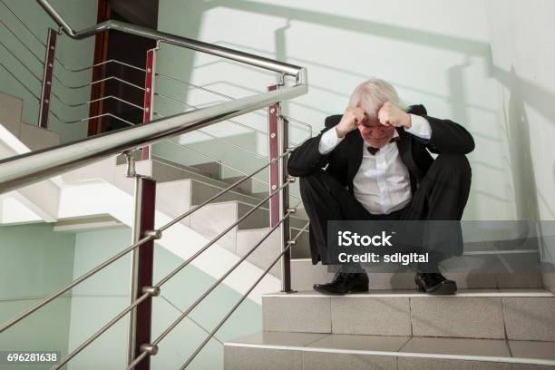 Man In A Tuxedo On A Metal Ladder Stock Photo - Download Image Now - Rejection, Adult, Adults Only