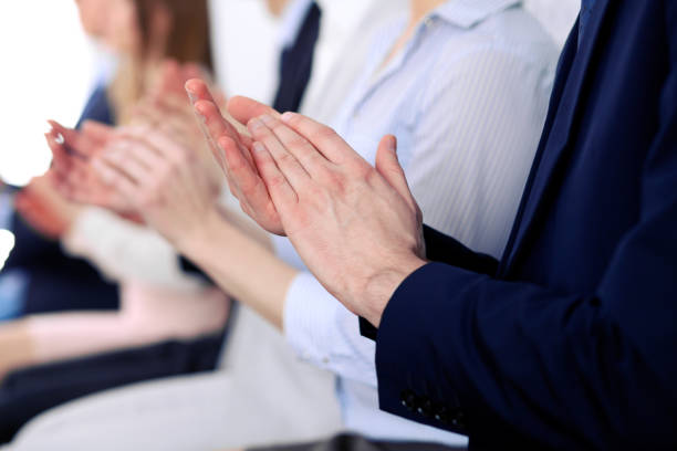 istock Close up of business people hands  clapping at conference 696281684