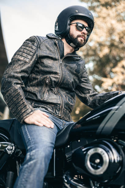 istock Handsome rider guy with beard in black biker jacket 696290224