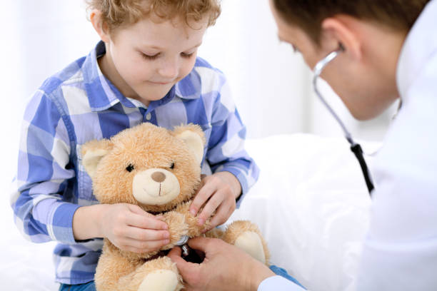 istock Doctor examining a child  patient by stethoscope 696296144