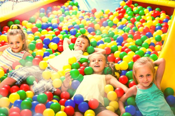 istock children playing together in pool with plastic multicolored balls 696296548