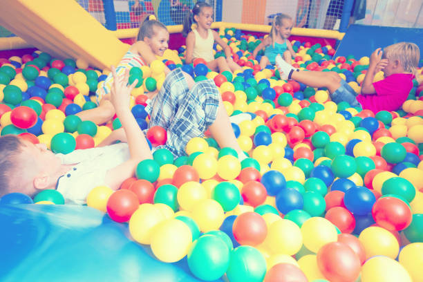 istock Group of kids playing on playground with plastic balls 696296582