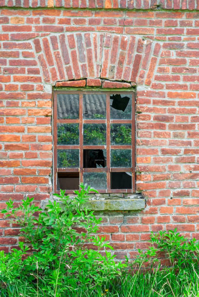 istock Old broken window in the abandoned church 696303916