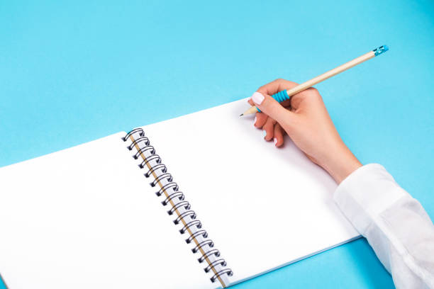 istock Spiral notepad with pencil as mockup for design 696307524