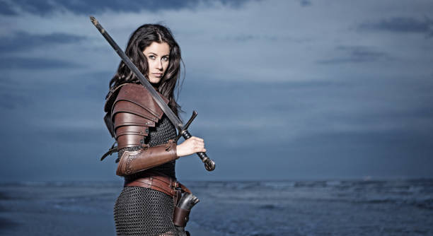 mujer de viking de pelo oscuro en el mar al atardecer - chainmail fotografías e imágenes de stock