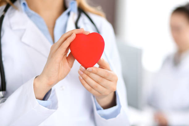 istock Female doctor with stethoscope holding heart. 696311606