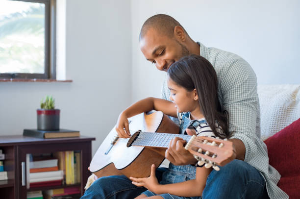 istock Father playing guitar with daughter 696314286