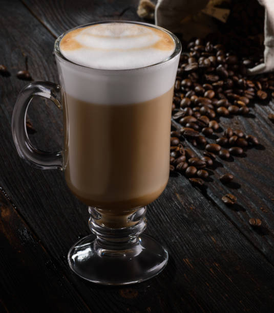 istock Irish Coffee with cappuccino foam on dark wooden background 696314402