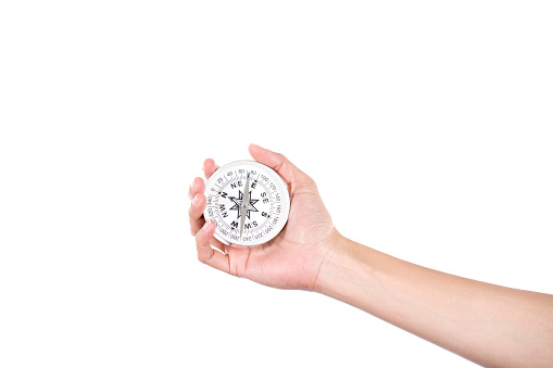 Traveler woman searching direction with a compass, on white background