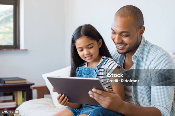 Father And Daughter Using Tablet Stock Photo - Download Image Now - Child, Family, Parent