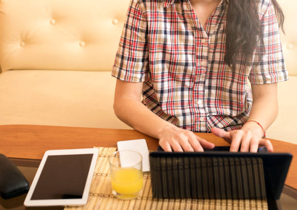 istock Woman using laptop at home 696317756