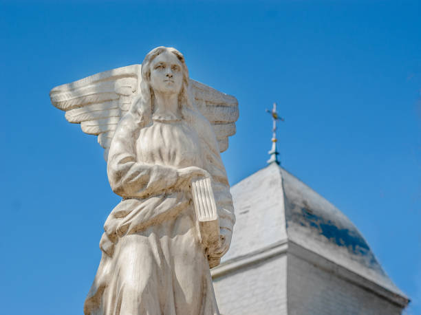 istock Angel statue Marble, Catholic Church, blue background 696318152