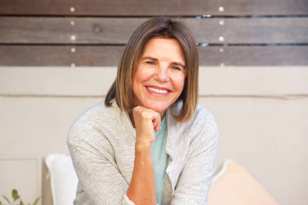 istock smiling older woman relaxing outside 696318394
