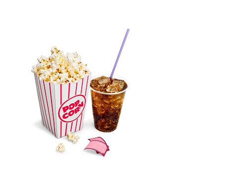 Popcorn in box and cola on white background