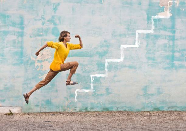 Running to the top Young woman is jumping in the air scoring run stock pictures, royalty-free photos & images
