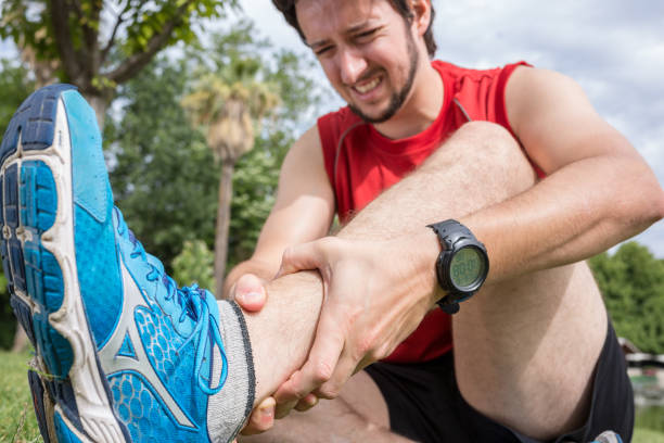 istock Ankle injury while jogging in the park, The man has wrong 696325378