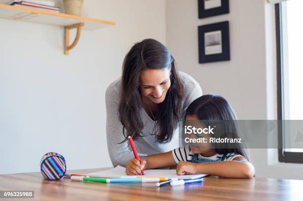 Mother Helping Daughter Draw Stock Photo - Download Image Now - Homework, Child, Mother