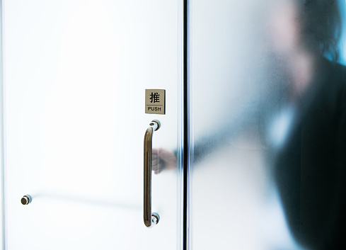 Businesswoman hand opening office door