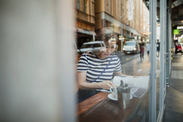 istock Young Woman at a Coffee Shop 696329162