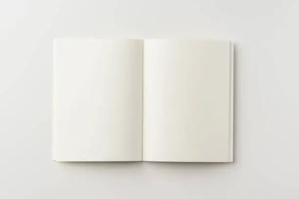 Photo of Top view of spiral blank notebook on white background