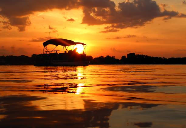 On the Pontoon A perfet sunset view from a Bangs Lake Pontoon pontoon boat stock pictures, royalty-free photos & images