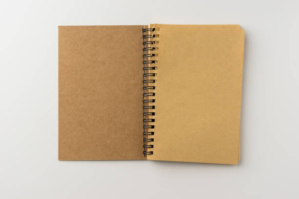 istock Top view of spiral blank notebook on white background 696333826