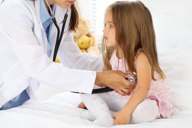 istock Doctor examining a little girl by stethoscope 696334040
