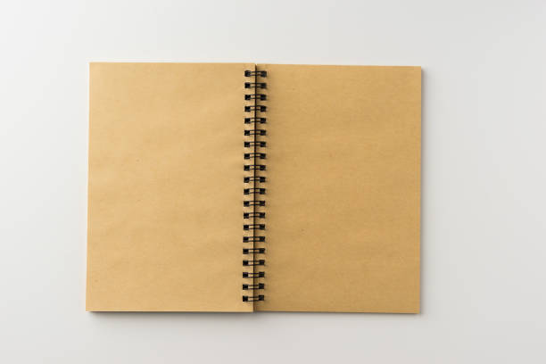 istock Top view of spiral blank notebook on white background 696334094