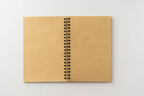 istock Top view of spiral blank notebook on white background 696334210