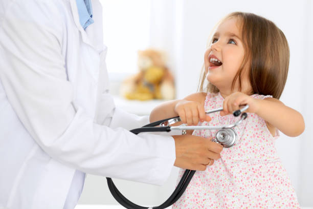 istock Doctor examining a little girl by stethoscope 696334532