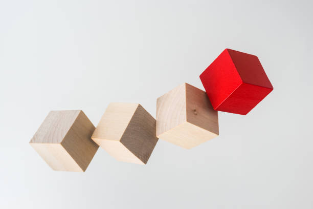 istock Abstract geometric real floating wooden cube on grey background 696342572