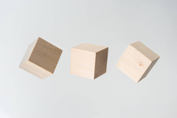 istock Abstract geometric real floating wooden cube on grey background 696342674