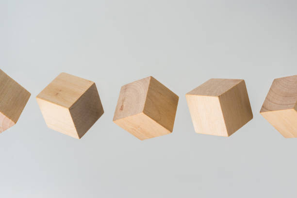 istock Abstract geometric real floating wooden cube on grey background 696342804