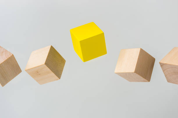 istock Abstract geometric real floating wooden cube on grey background 696345018