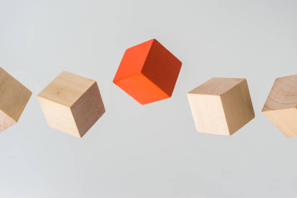 istock Abstract geometric real floating wooden cube on grey background 696345236