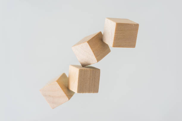 istock Abstract geometric real floating wooden cube on grey background 696345494