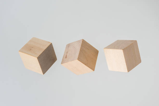 istock Abstract geometric real floating wooden cube on grey background 696345544