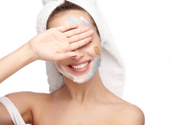 istock Woman applying cosmetics and closing eyes 696345868