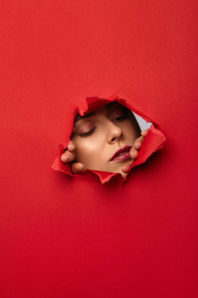 istock Woman tearing paper from behind 696346286