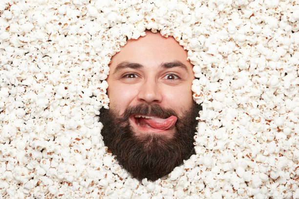 istock Man with tongue out in popcorn 696347064