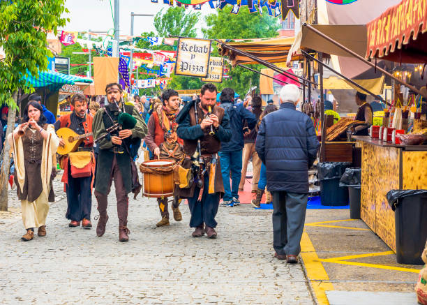 El Alamo, Madrid, Spain - April 30, 2017: A group of street musicians entertain people in the medieval market of El Alamo in Madrid.
