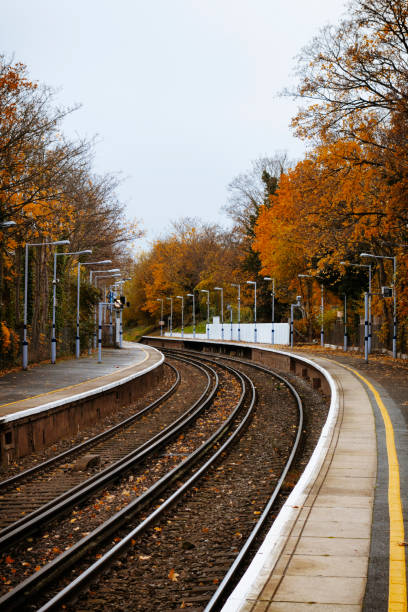 istock 'Leaves on the line' - British railway station in autumn 696357358