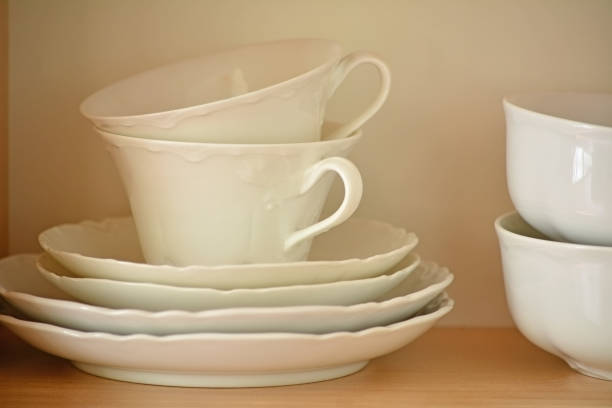 istock White dishes on wooden shelf 696357478