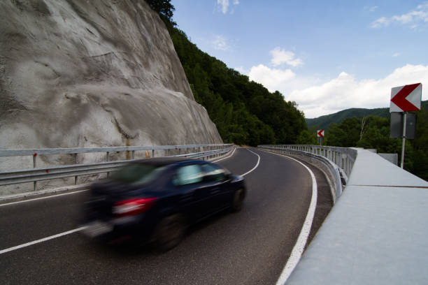 istock black car on steep mountain road 696363846