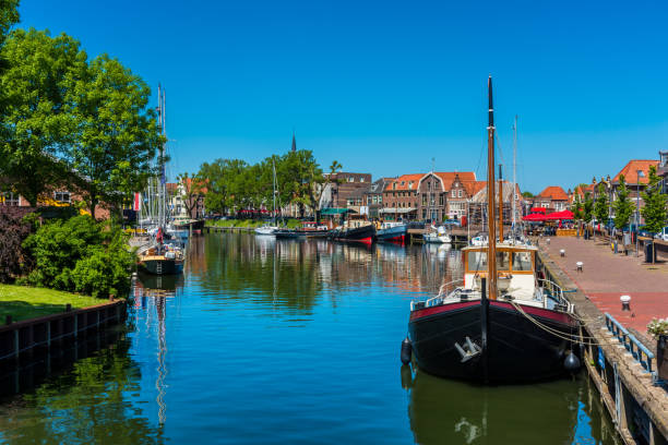 Ships in Canal in City Center of Enkhuizen Netherlands Ships in Canal in City Center of Enkhuizen Netherlands enkhuizen stock pictures, royalty-free photos & images