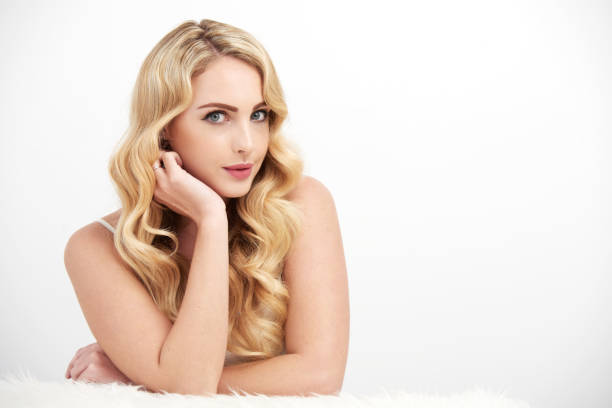 istock Angelic Young Woman Posing on White 696364308