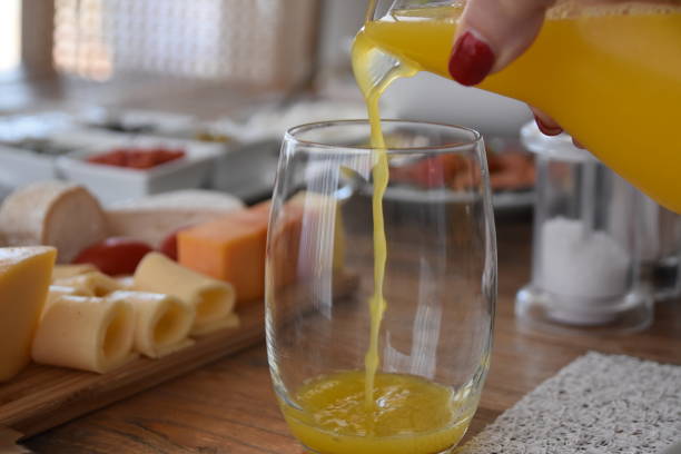 istock Pour orange juice into a glass 696365168