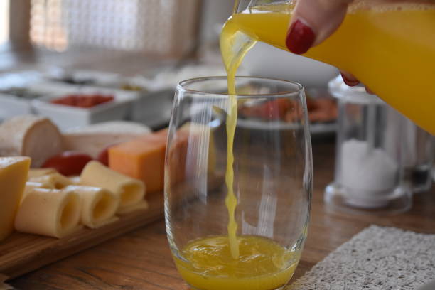 istock Pour orange juice into a glass 696365610